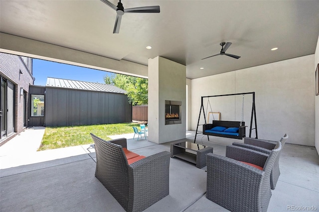 3057 S University Cir, Englewood, CO 80113 - view of patio / terrace with a ceiling fan and an outdoor living space with a fireplace