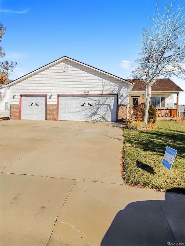 ranch-style home with a garage and a front yard