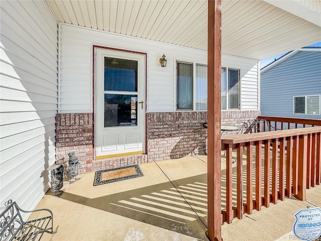 view of exterior entry with covered porch