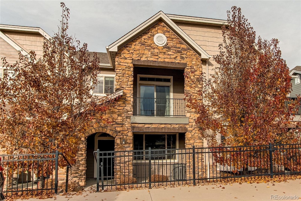 view of front of house featuring a balcony