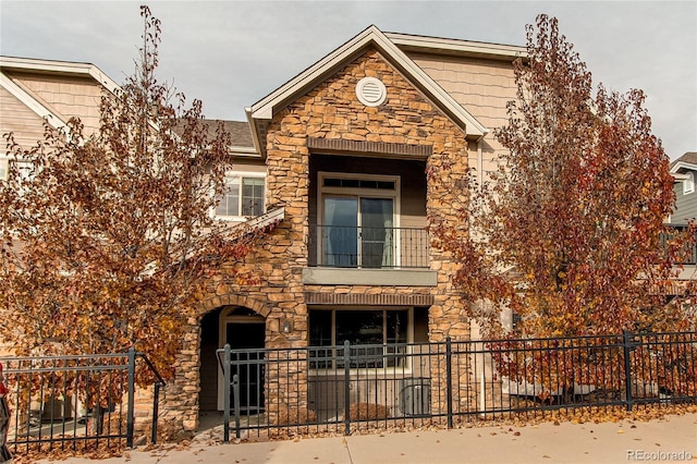 view of front of house featuring a balcony