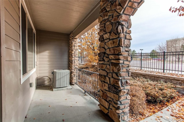 balcony with a water view and central AC