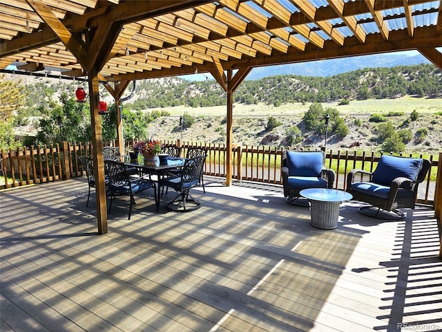11679 US Highway 50, Howard, CO 81233 - wooden deck featuring a pergola, outdoor dining area, and a mountain view