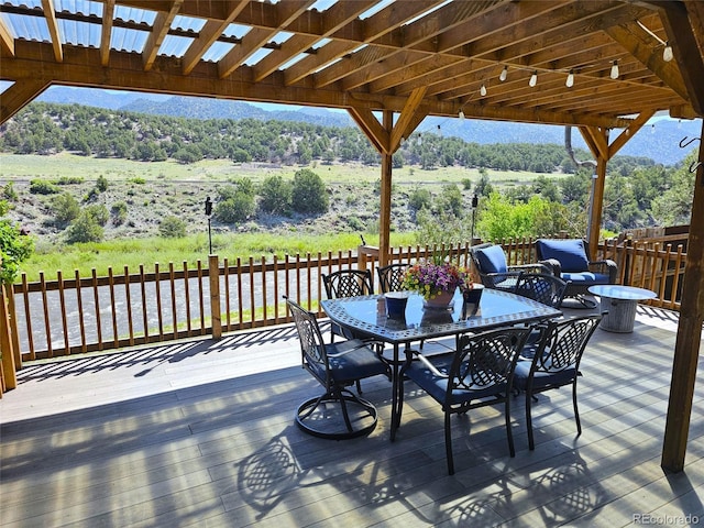 11679 US Highway 50, Howard, CO 81233 - wooden terrace with outdoor dining area and a wooded view