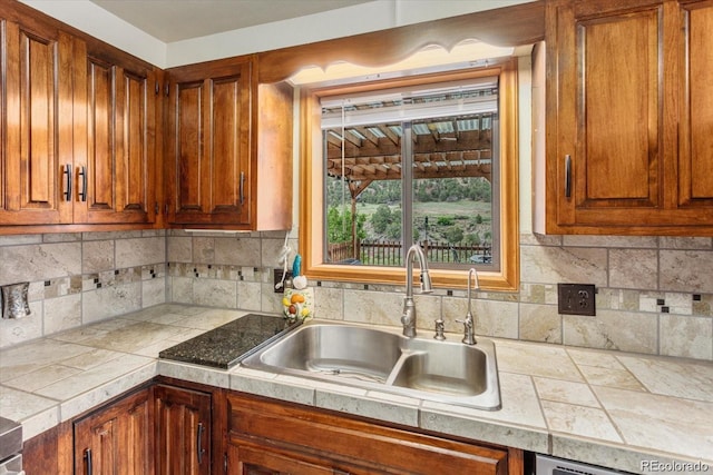 11679 US Highway 50, Howard, CO 81233 - kitchen with a sink, brown cabinetry, and tasteful backsplash