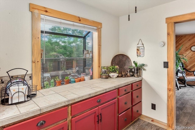 11679 US Highway 50, Howard, CO 81233 - kitchen with red cabinets, light countertops, and dark wood-style flooring