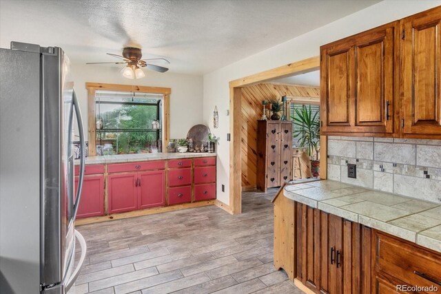 11679 US Highway 50, Howard, CO 81233 - kitchen featuring freestanding refrigerator, ceiling fan, backsplash, and light wood-type flooring
