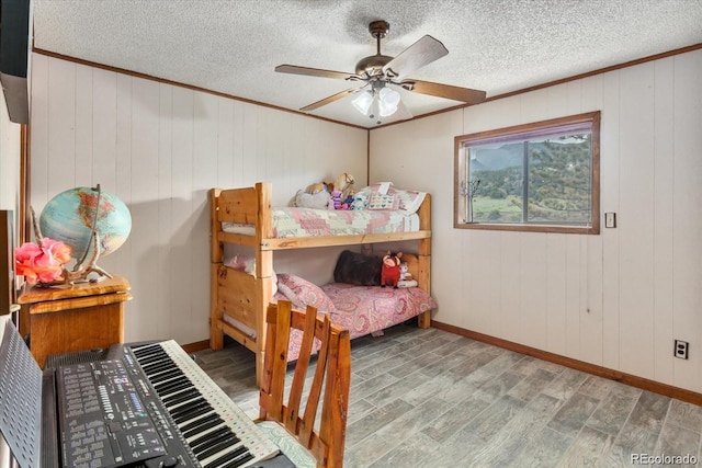 11679 US Highway 50, Howard, CO 81233 - bedroom featuring crown molding, wood finished floors, baseboards, a textured ceiling, and ceiling fan