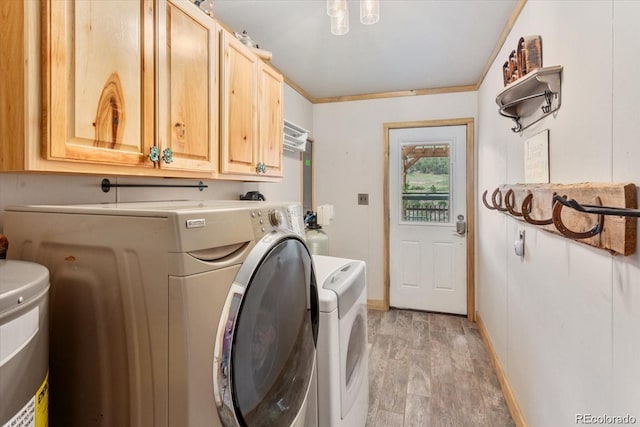11679 US Highway 50, Howard, CO 81233 - washroom featuring washer and clothes dryer, cabinet space, and light wood-style flooring