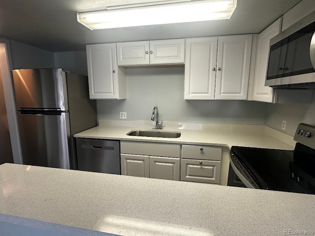 kitchen with white cabinets, stainless steel appliances, and sink