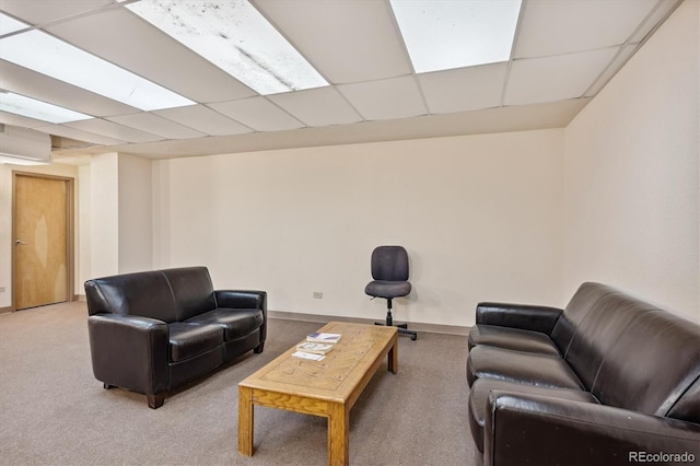 carpeted living room with a paneled ceiling