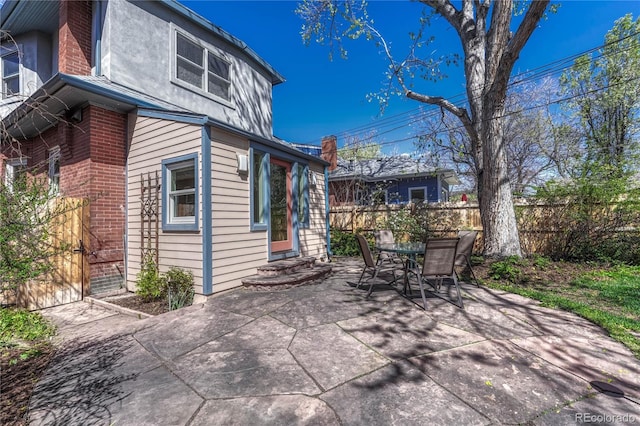 view of patio / terrace featuring fence and outdoor dining area