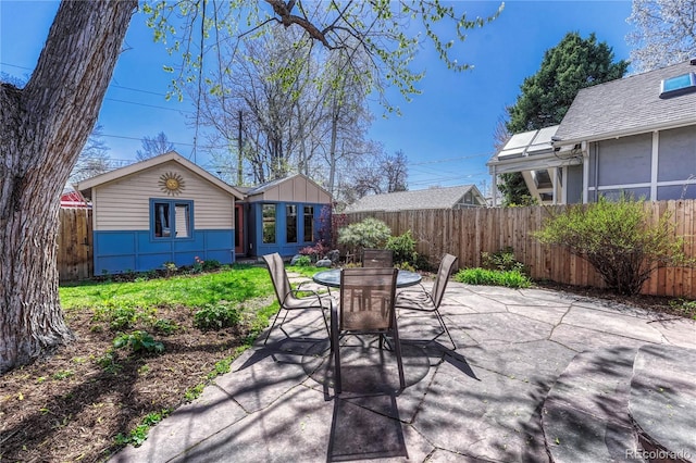 view of patio with a fenced backyard and outdoor dining space