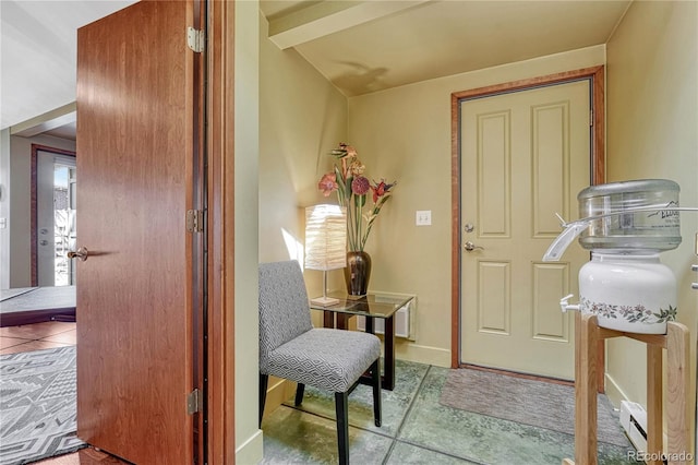 sitting room with tile patterned floors, baseboards, and lofted ceiling
