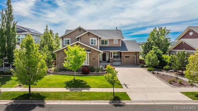 26741 E Arbor Dr, Aurora, CO 80016 - craftsman house featuring driveway, an attached garage, a front lawn, and stone siding