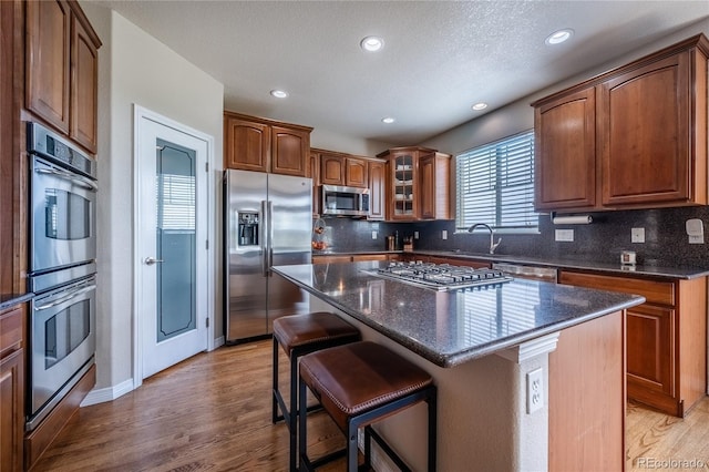 26741 E Arbor Dr, Aurora, CO 80016 - kitchen with stainless steel appliances, light wood-type flooring, tasteful backsplash, and recessed lighting