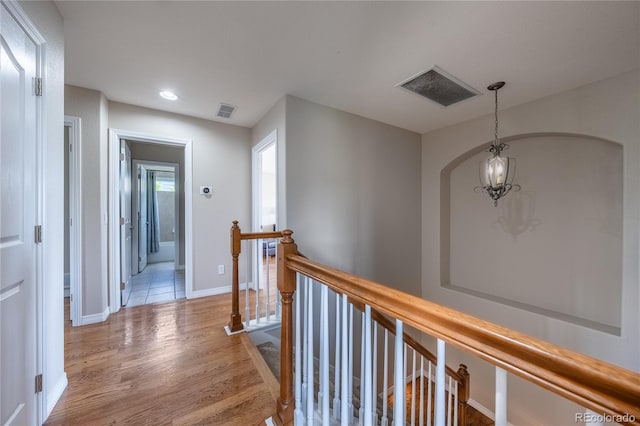 26741 E Arbor Dr, Aurora, CO 80016 - hallway featuring an upstairs landing, light wood-type flooring, arched walkways, baseboards, and recessed lighting