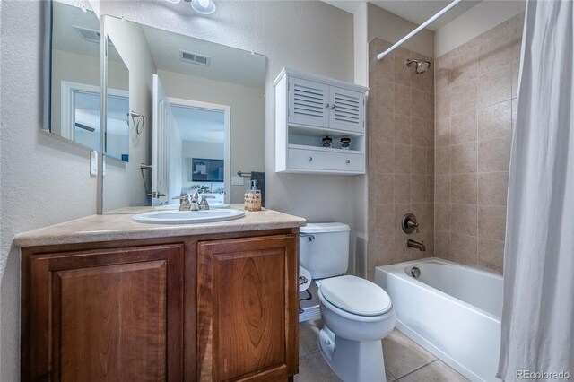 26741 E Arbor Dr, Aurora, CO 80016 - bathroom featuring shower / bath combo with shower curtain, toilet, vanity, tile patterned floors, and a textured wall