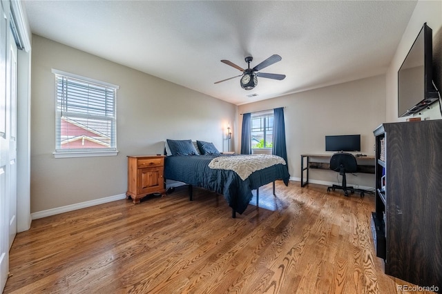 26741 E Arbor Dr, Aurora, CO 80016 - bedroom with light wood-type flooring, an office area, baseboards, and a ceiling fan