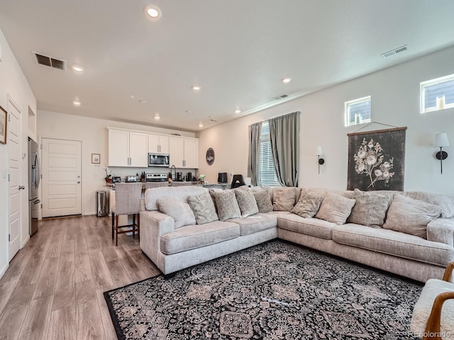 17991 E 103rd Ave, Commerce City, CO 80022 - living area with light wood-style floors and recessed lighting