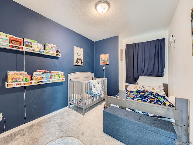 17991 E 103rd Ave, Commerce City, CO 80022 - bedroom featuring carpet, a textured ceiling, baseboards, and a crib