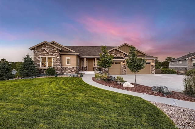 craftsman house featuring a garage and a lawn