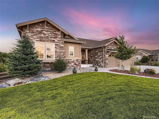 craftsman-style home with a lawn and a garage