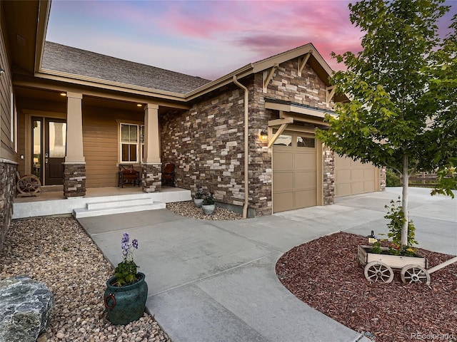 view of front of property featuring a porch and a garage