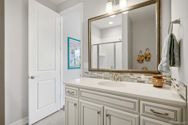 bathroom with backsplash, vanity, and walk in shower