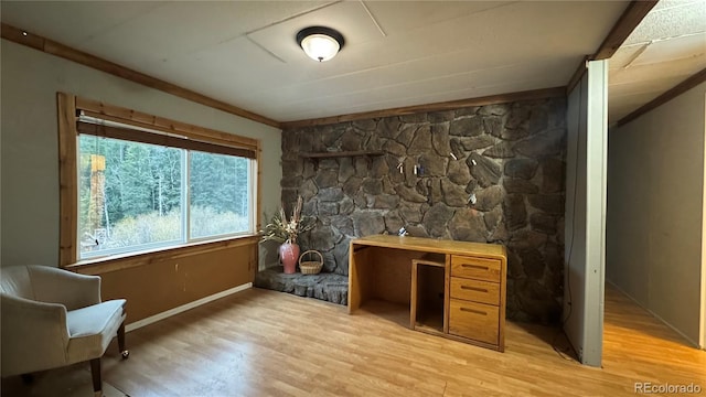 office space with baseboards, ornamental molding, and light wood finished floors