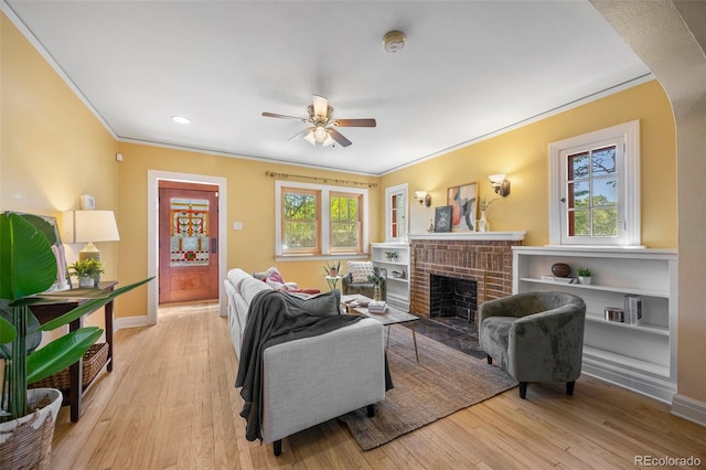 1601 Albion St, Denver, CO 80220 - living area with ornamental molding, ceiling fan, a fireplace, wood finished floors, and baseboards