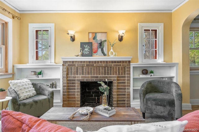 1601 Albion St, Denver, CO 80220 - living room featuring arched walkways, a fireplace, and crown molding