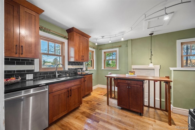 1601 Albion St, Denver, CO 80220 - kitchen with dishwasher, a sink, tasteful backsplash, light wood-style flooring, and plenty of natural light