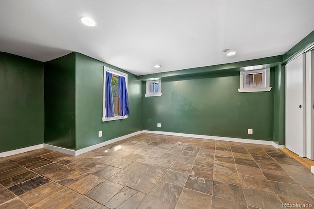 1601 Albion St, Denver, CO 80220 - below grade area featuring stone tile floors, baseboards, and recessed lighting