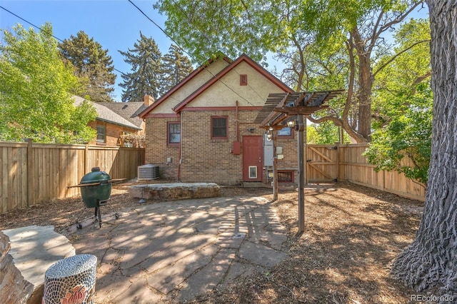 1601 Albion St, Denver, CO 80220 - rear view of house with brick siding, a fenced backyard, central air condition unit, and a patio area