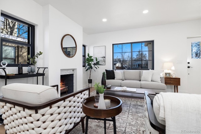 living room with a premium fireplace and recessed lighting