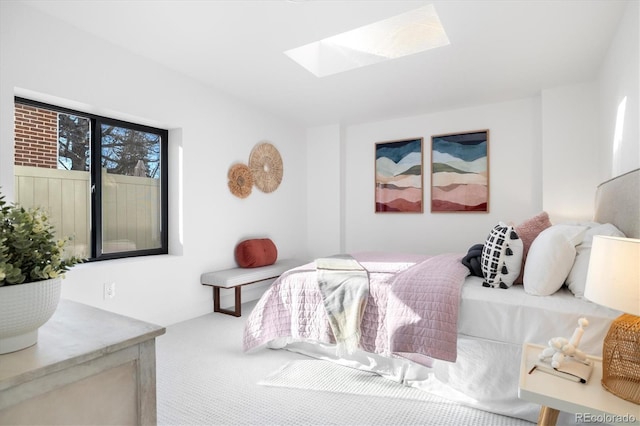 carpeted bedroom featuring a skylight