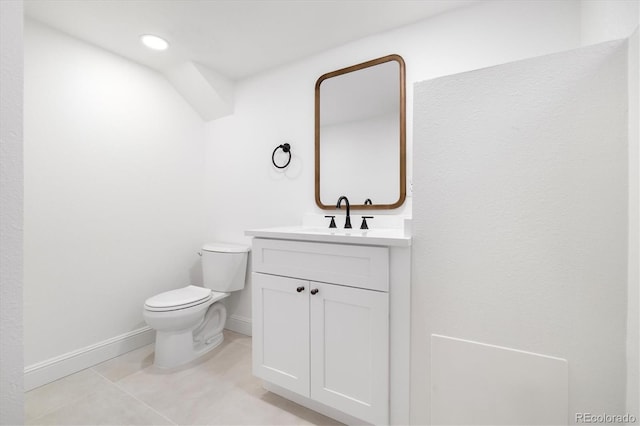 bathroom with toilet, tile patterned floors, baseboards, and vanity