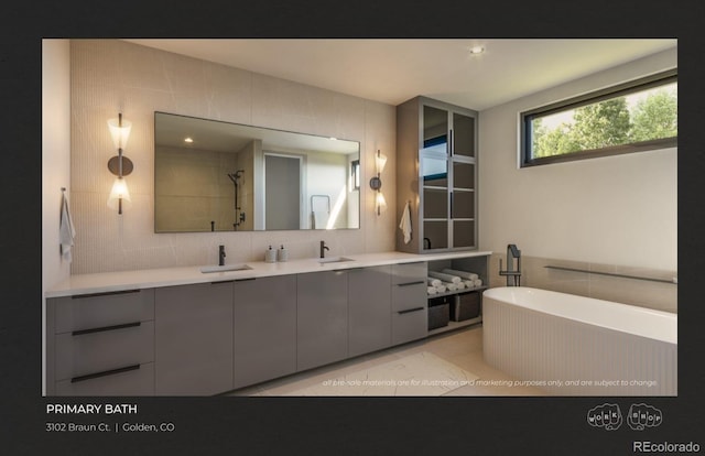 bathroom featuring tile walls, vanity, shower with separate bathtub, and tile patterned floors