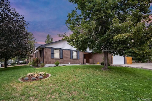 7651 Robb St, Arvada, CO 80005 - ranch-style house featuring brick siding, a garage, a front yard, and concrete driveway