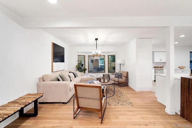 7651 Robb St, Arvada, CO 80005 - living area with light wood finished floors, a chandelier, and recessed lighting