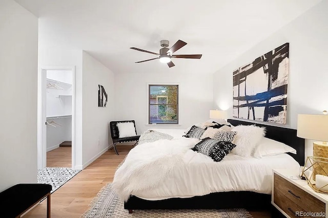 7651 Robb St, Arvada, CO 80005 - bedroom featuring wood finished floors, a spacious closet, and a ceiling fan