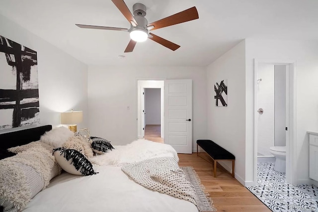 7651 Robb St, Arvada, CO 80005 - bedroom featuring light wood-type flooring, ensuite bathroom, and ceiling fan