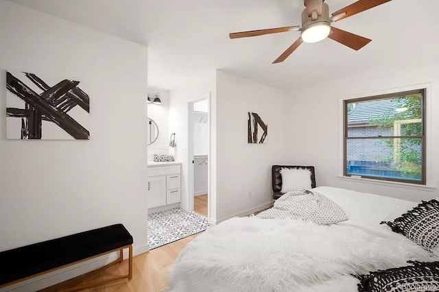 7651 Robb St, Arvada, CO 80005 - bedroom with light wood finished floors, a ceiling fan, and connected bathroom