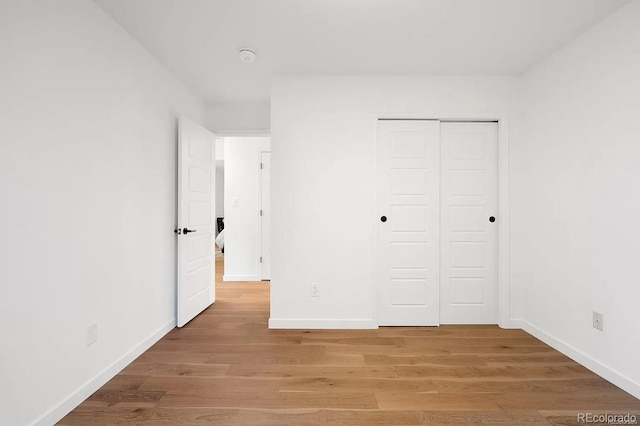 7651 Robb St, Arvada, CO 80005 - unfurnished bedroom with a closet and light wood-style floors