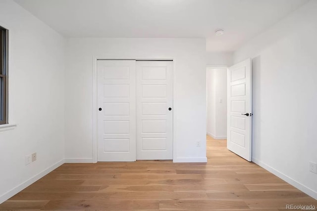 7651 Robb St, Arvada, CO 80005 - unfurnished bedroom featuring a closet and light wood-style floors