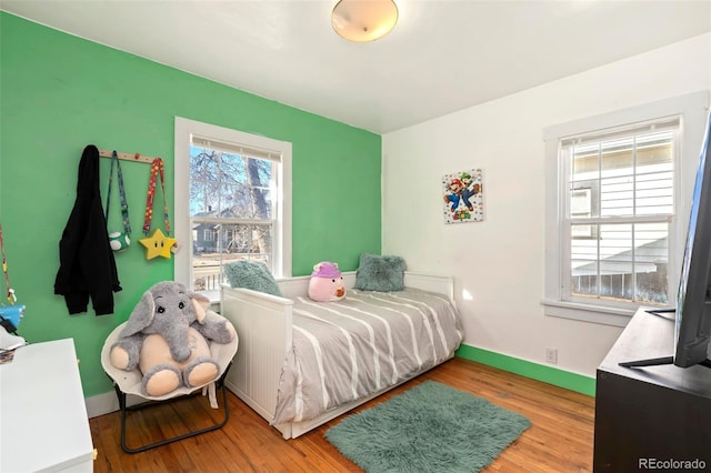 bedroom featuring baseboards and wood finished floors