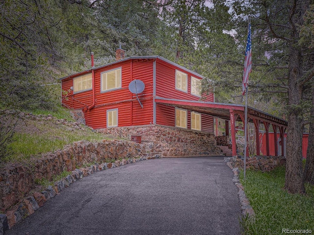 6837 S Brook Forest Rd, Evergreen, CO 80439 - view of front of property featuring asphalt driveway, a chimney, and faux log siding