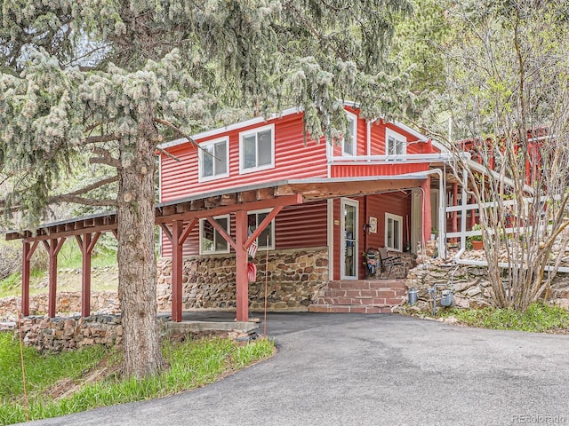 6837 S Brook Forest Rd, Evergreen, CO 80439 - chalet / cabin featuring stone siding, covered porch, and log veneer siding