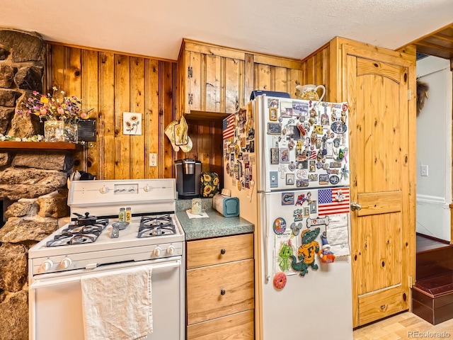 6837 S Brook Forest Rd, Evergreen, CO 80439 - kitchen featuring white appliances and wooden walls